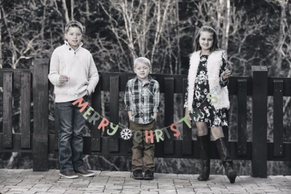 Children holding Merry Christmas sign